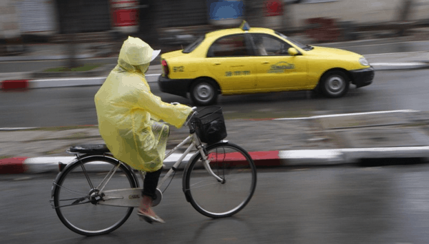 Ponchos are a popular rain attire for bikers around the city. 