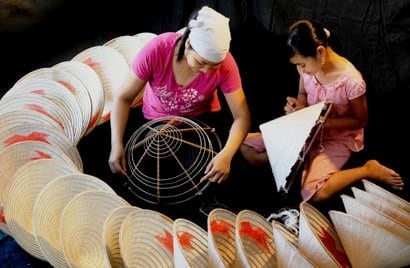 Workers in the Chuong village creating the hats by hand. 