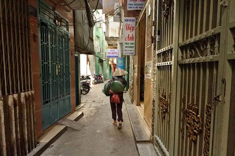 Quiet alley with beautiful doors on either side. 