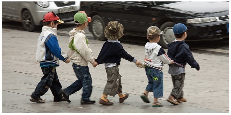 Local children crossing the road in Saigon, although we recommend that they have adults on either side of them.