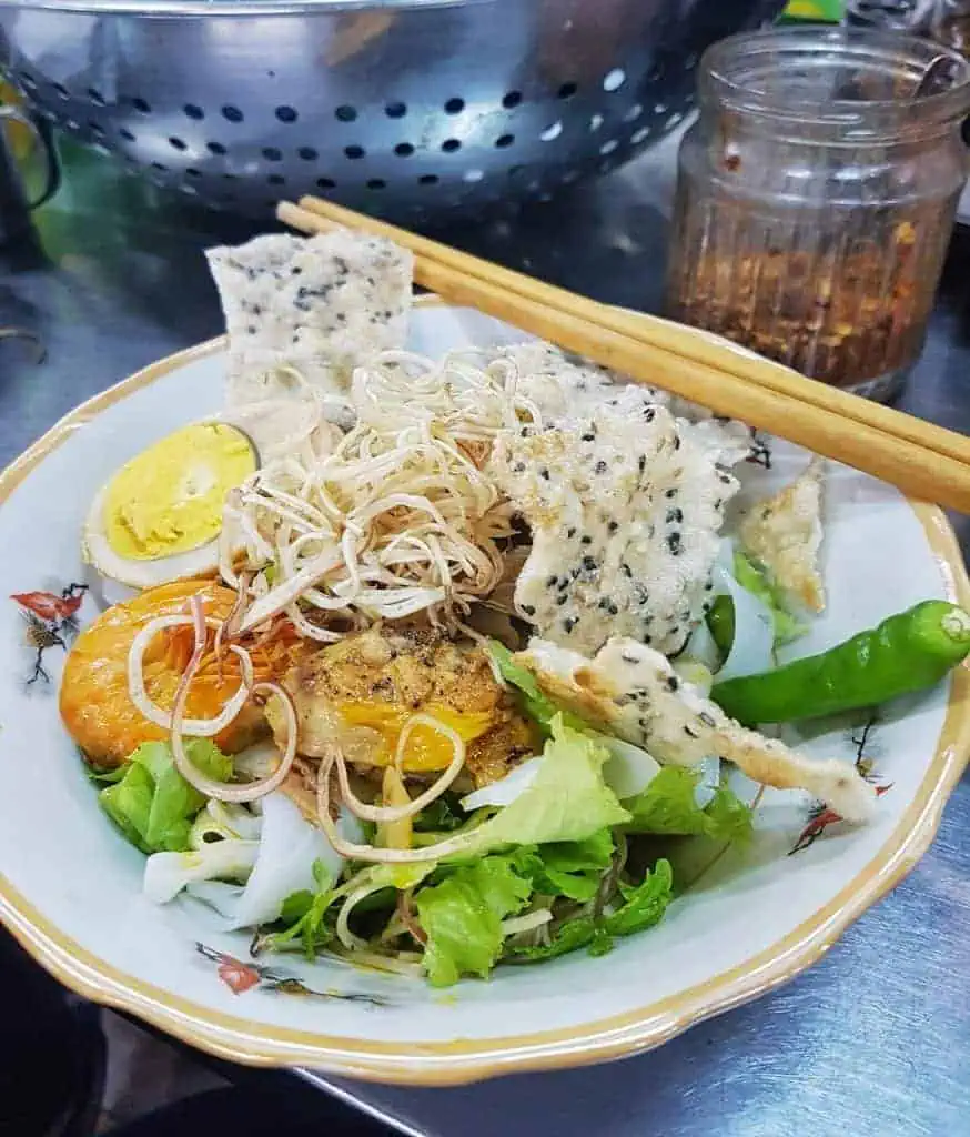 Mi Quang Noddle in Hoi An with green lettuce, shrimp and chicken