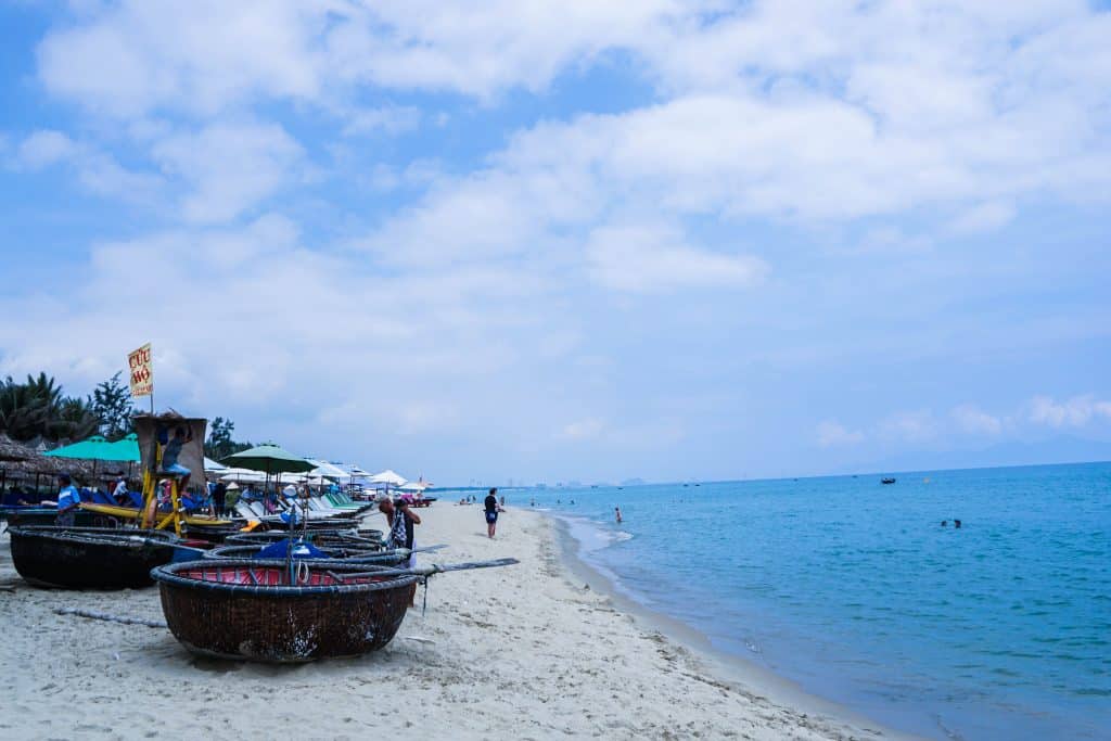 Hoi An beach with fishing boat and blue sky