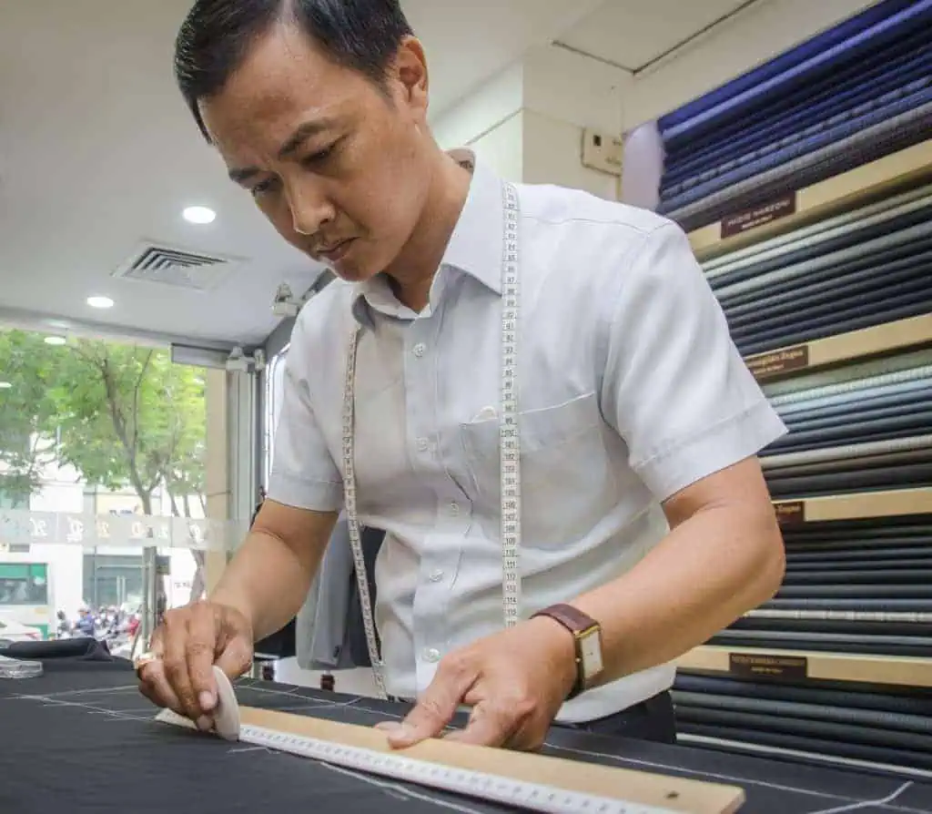 One of the best tailors in Hoi An measuring cloth