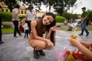 Female traveler buying street food