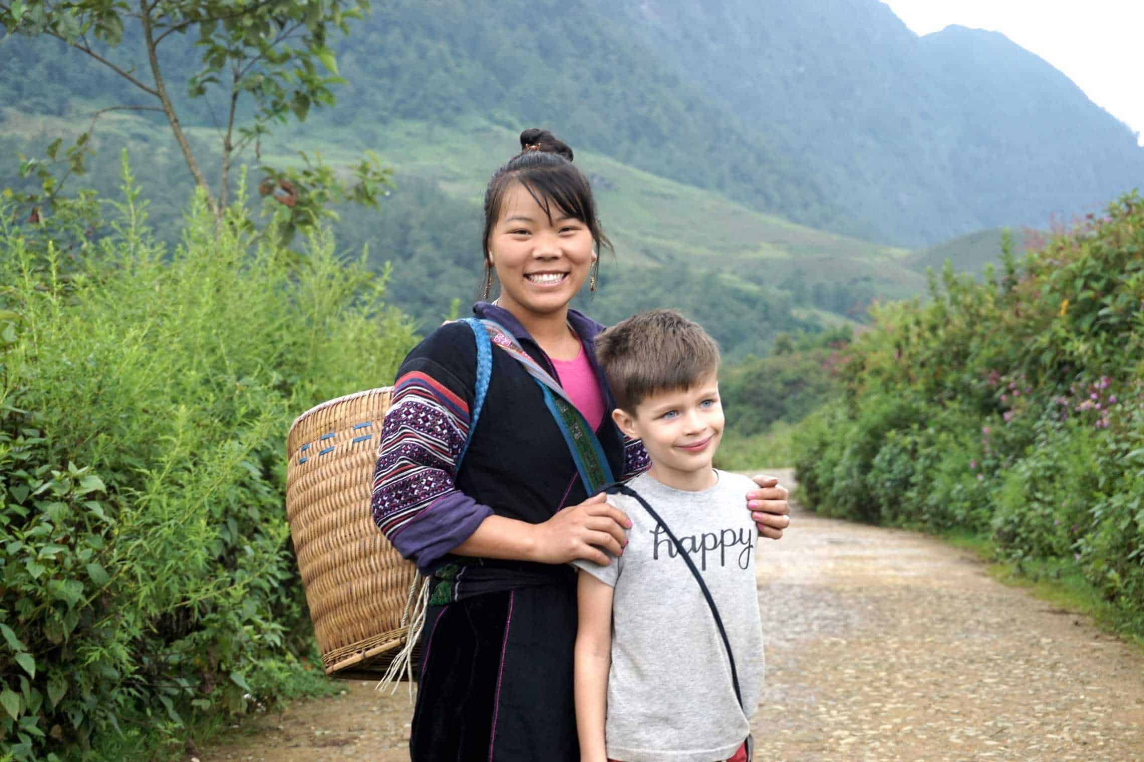 Ethnic villager in Vietnam posing with a foreign child