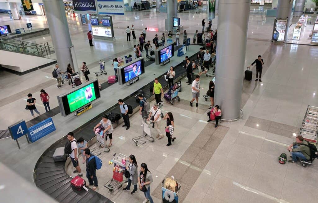 Collecting baggage from the carousel belt after landing at a Vietnam airport