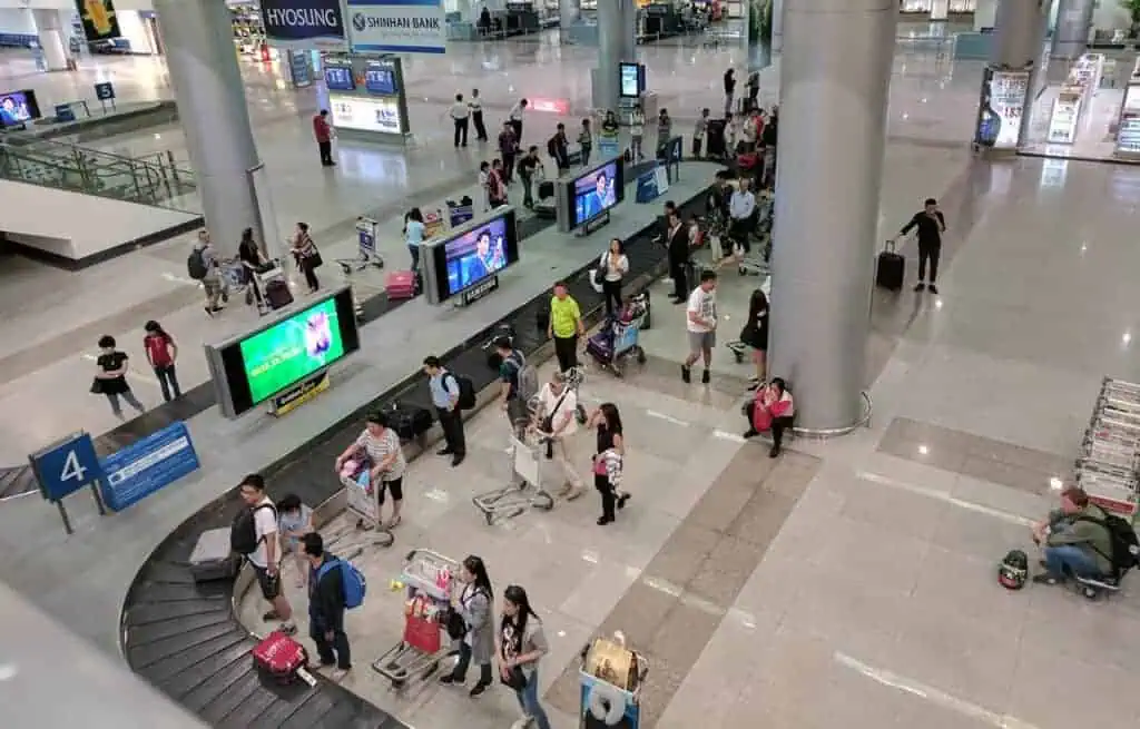 Collecting baggage from the carousel belt after landing at a Vietnam airport