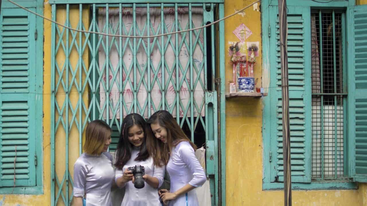 looking at a camera on Saigon Photography Tour